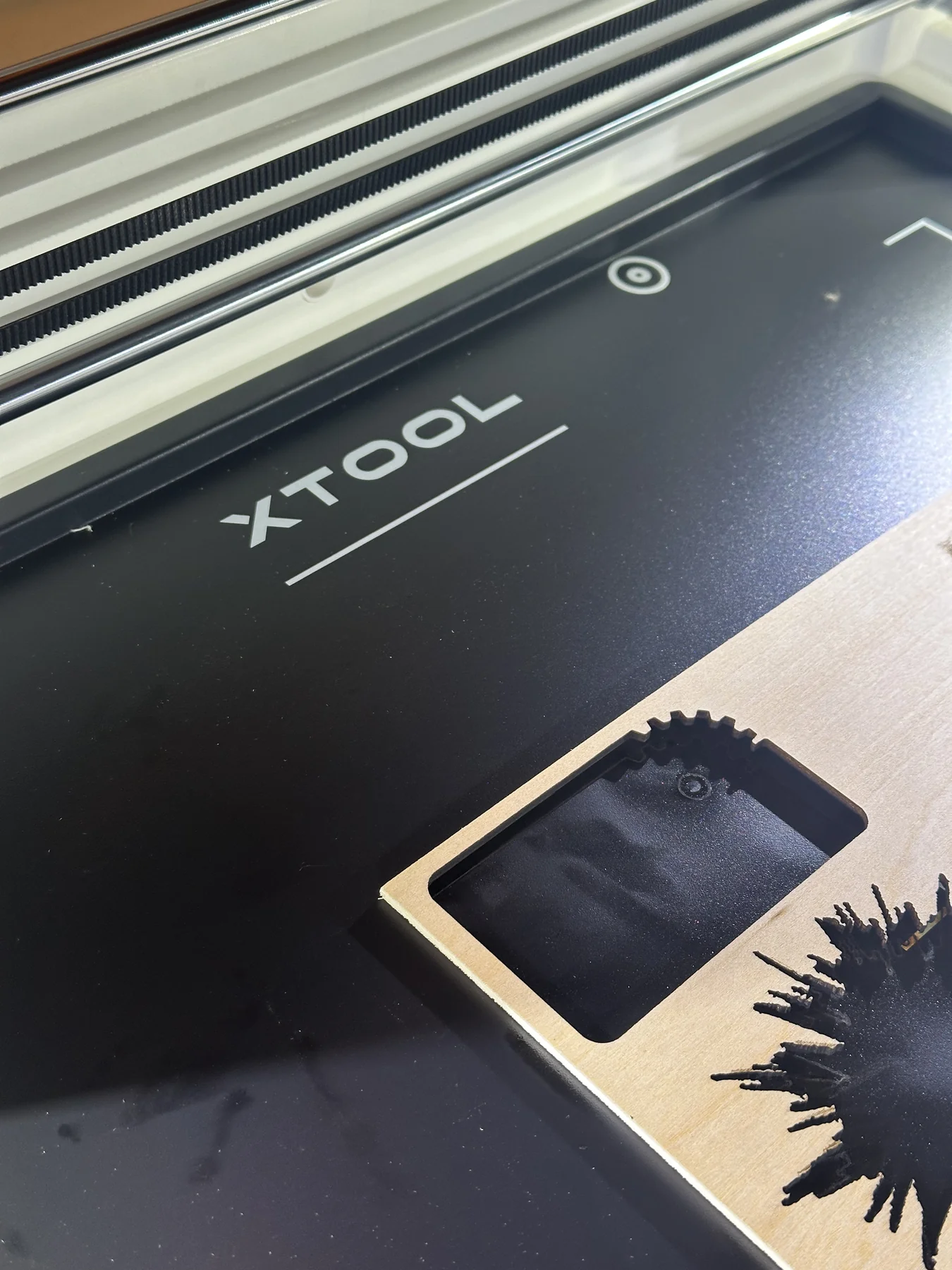 Business card being produced on the laser engraver
