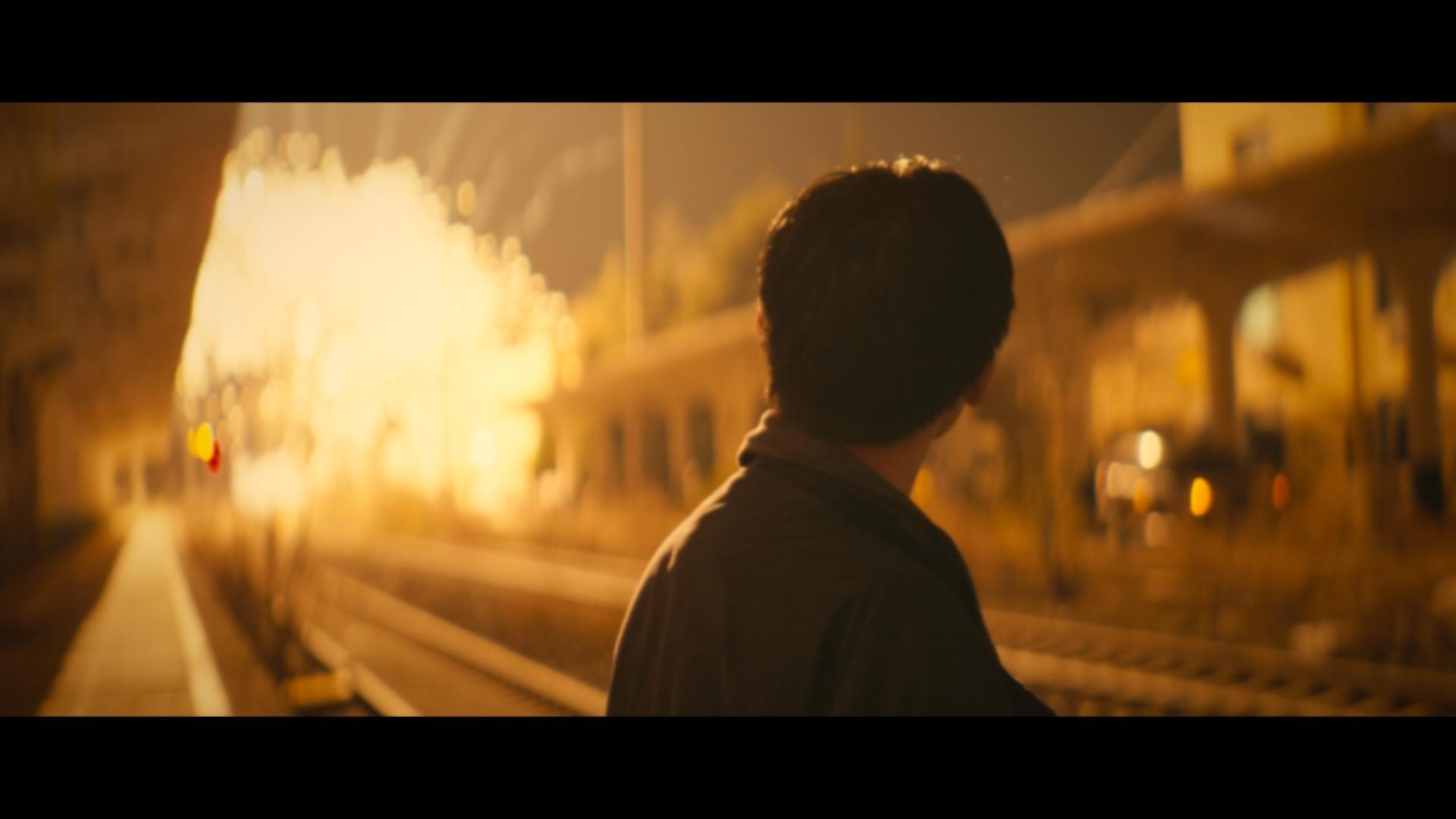 Film 01 cover: a figure beside a train at night